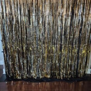 Gold foil fringe backdrop with shimmering gold fringe for parties and events.