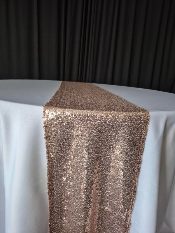 Rose gold sequin runners displayed on an event table.