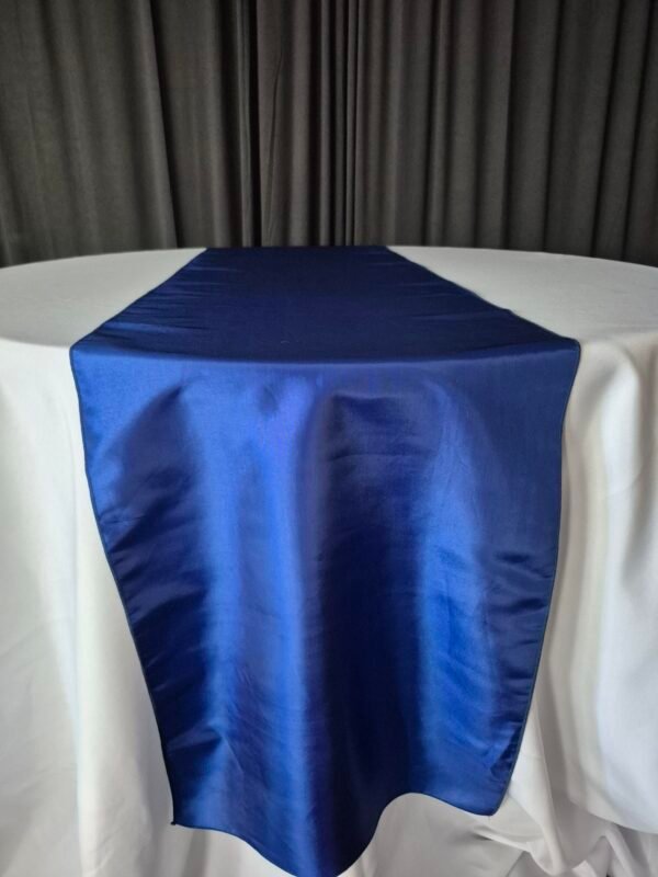 Royal blue table runners on an event table.