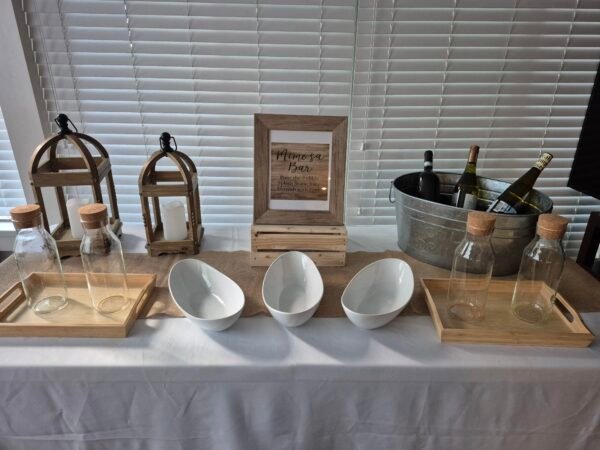 Rustic bar table with Elegance Mimosa setup for events and parties.