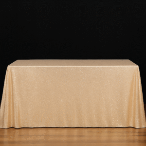 Champagne sequin rectangle tablecloth on an event table.