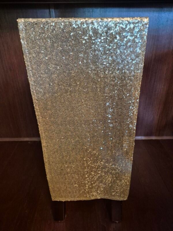 Champagne sequin runners displayed for event or party.