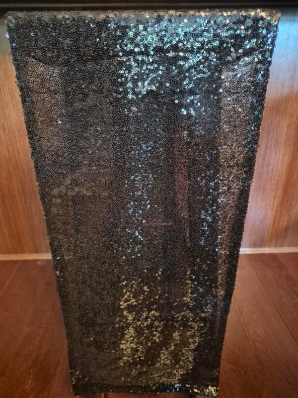 Black runners placed on an event table for elegant décor.