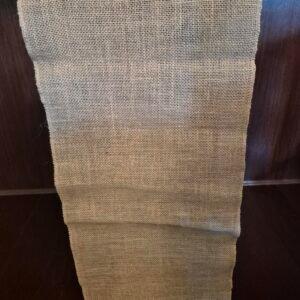 Rustic burlap table runners displayed on an event table.