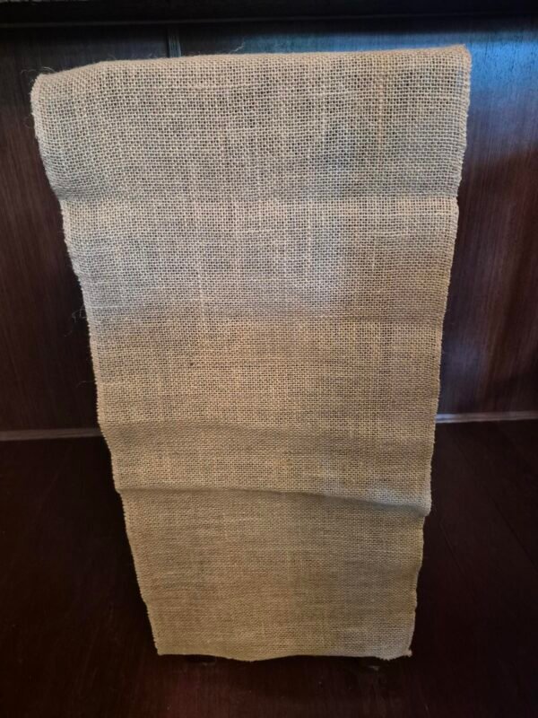 Rustic burlap table runners displayed on an event table.